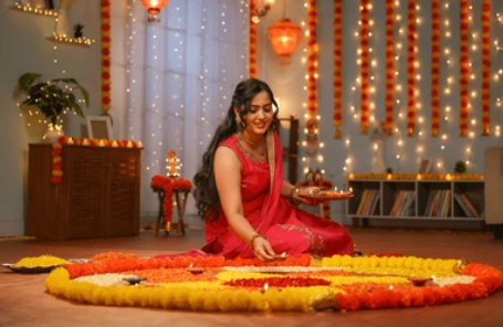Traditional Indian woman performing puja and worship with diyas and flowers in a temple setting